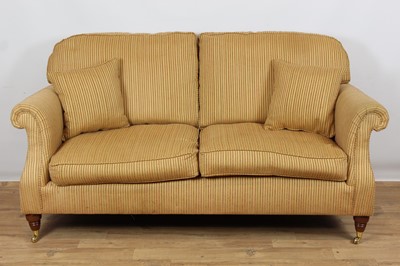 Lot 976 - Traditional three piece suite upholstered in stripe material on turned mahogany legs with brass castors