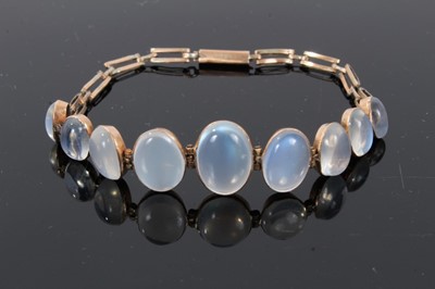 Lot 309 - Moonstone bracelet with nine oval cabochon moonstones in rose gold setting, the moonstones graduating from approximately 8.5mm x 5mm to 13.5mm x 9.5mm with gold links, length approximately 18cm