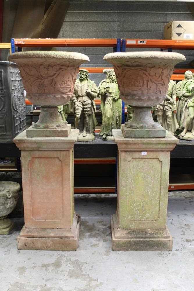 Lot 854 - Monumental pair of ceramic garden urns on plinths