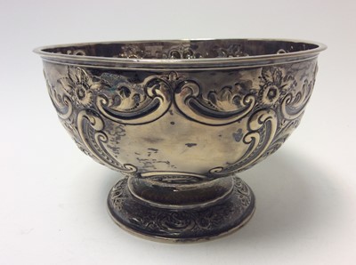 Lot 185 - Victorian silver Rose Bowl of conventional form with embossed floral, foliate and scroll decoration, raised on a circular pedestal foot, (Sheffield 1897), maker James Deakin & Sons, 21.5cm in diame...