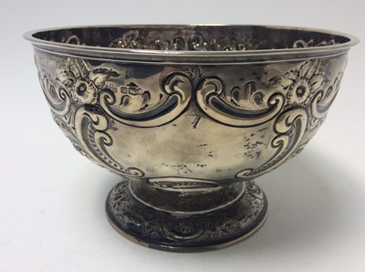 Lot 185 - Victorian silver Rose Bowl of conventional form with embossed floral, foliate and scroll decoration, raised on a circular pedestal foot, (Sheffield 1897), maker James Deakin & Sons, 21.5cm in diame...