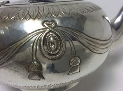 Lot 186 - Victorian silver bachelors teapot of bullet form, with engraved acanthus leaf borders, embossed ribbon and swag decoration, hinged cover with fluted ebony finial and ebony loop handle, on circular...