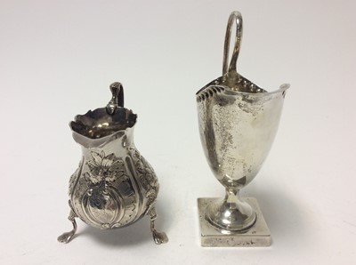 Lot 187 - George III silver cream jug of baluster form, raised on three hoof feet, (London 1764), together with a Victorian silver cream jug of helmet form, (Birmingham 1876), Georgian cream jug 9.8cm  in he...