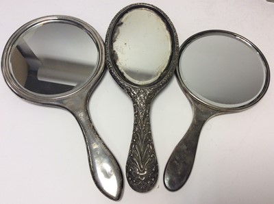 Lot 193 - Late Victorian silver hand mirror with ornate embossed floral and scroll decoration (Birmingham 1900), together with two other silver hand mirrors and various silver mounted cut glass dressing tabl...