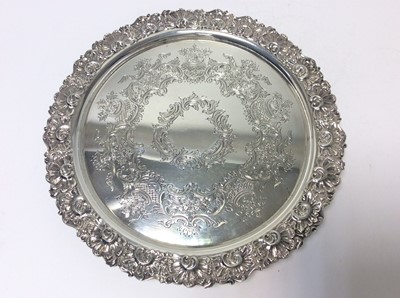 Lot 196 - Edwardian silver salver of circular form engraved foliate and scroll decoration, with scroll border, raised on three scroll feet, (Sheffield 1904), maker Marples & Co, 24oz, 26cm in diameter