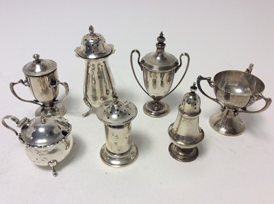 Lot 209 - Late Victorian silver pepperette of baluster form, rasied on three hoof feet (Birmingham 1900) together with other silver pepperettes, mustard pot and other silver items (various dates and makers),...