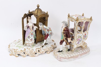 Lot 121 - Two continental porcelain carriage groups, both polychrome painted and gilt and one with a brass carriage, one measuring 25.5cm height x 28.5cm width and the other 22.5cm height x 21.5cm width