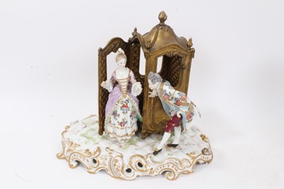 Lot 121 - Two continental porcelain carriage groups, both polychrome painted and gilt and one with a brass carriage, one measuring 25.5cm height x 28.5cm width and the other 22.5cm height x 21.5cm width