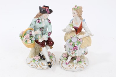 Lot 122 - Six pairs of Sitzendorf porcelain figures, mostly with floral encrusted scrollwork bases, printed marks, between 11cm and 19cm height