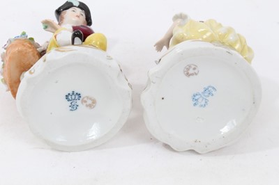 Lot 122 - Six pairs of Sitzendorf porcelain figures, mostly with floral encrusted scrollwork bases, printed marks, between 11cm and 19cm height