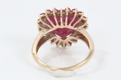 Lot 343 - Ruby and gold heart shaped cluster ring with a large heart-shaped ruby (ruby fracture filled) surrounded by a border of mixed cut rubies on 9ct yellow gold shank. Ring size M.