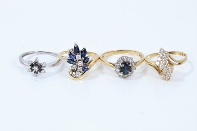 Lot 344 - Group of four diamond and sapphire rings to include an 18ct diamond asymmetric cluster ring, an 18ct gold marquise cut blue sapphire and brilliant cut diamond asymmetric cluster ring, an 18ct gold...