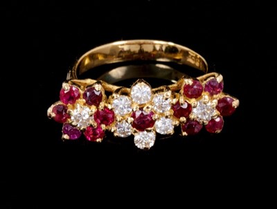 Lot 262 - Ruby and diamond triple flower head cluster ring with three clusters of brilliant cut diamonds and mixed cut rubies in gold claw setting on 18ct. Estimated total diamond weight approximately 0.45ct...