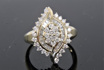 Lot 294 - Diamond cluster ring with an asymmetric cluster of brilliant cut and baguette cut diamonds in channel and claw setting on 9ct gold shank. Estimated total diamond weight approximately 0.80cts. Ring...