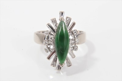 Lot 300 - Jade and diamond cluster cocktail ring with a marquise shaped green jade measuring approximately 13.5mm x 4.5mm surrounded by a border of single cut diamonds and illusion white gold setting on 18ct...