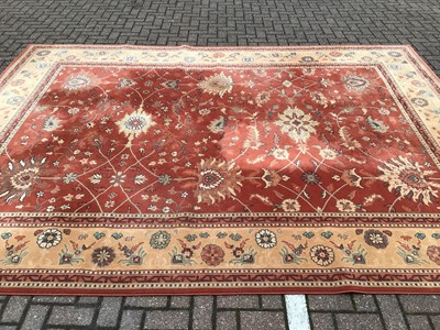 Lot 226 - Large rug with floral decoration on red and beige ground