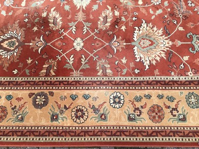 Lot 226 - Large rug with floral decoration on red and beige ground