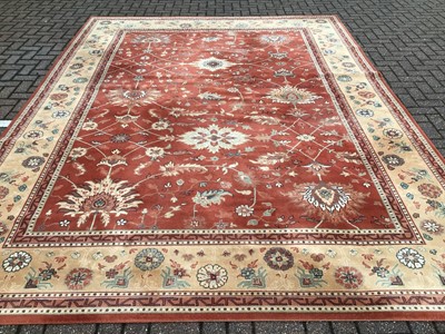 Lot 226 - Large rug with floral decoration on red and beige ground