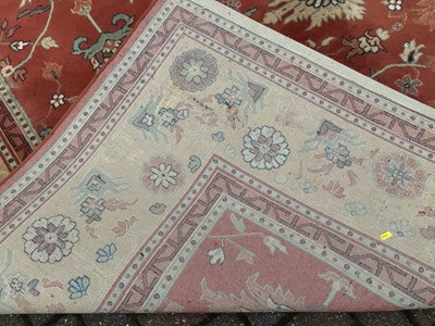 Lot 226 - Large rug with floral decoration on red and beige ground