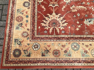 Lot 226 - Large rug with floral decoration on red and beige ground