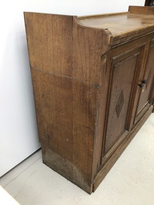 Lot 57 - Late Victorian oak cupboard with two panelled doors