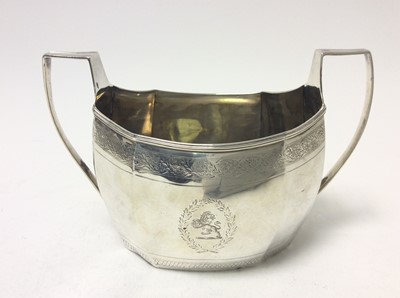 Lot 215 - Georgian Scottish Provincial silver twin handled sugar bowl of faceted octagonal form, with bands of bright cut decoration, reeded borders and an engraved armorial crest. Maker's mark only WS, poss...