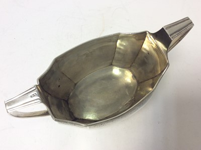 Lot 215 - Georgian Scottish Provincial silver twin handled sugar bowl of faceted octagonal form, with bands of bright cut decoration, reeded borders and an engraved armorial crest. Maker's mark only WS, poss...