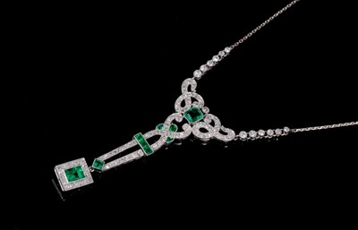 Lot 253 - Edwardian style emerald and diamond pendant necklace with a rectangular step cut emerald and diamond cluster suspended from openwork diamond scrolls with further emeralds,  old cut and single cut d...