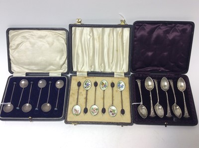 Lot 225 - Set of six George V silver coffee spoons with enamel terminals, (Birmingham 1928), maker Langstone Silver Works, in an associated case, together with a set of six Elizabeth II silver gilt and guill...