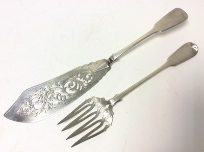 Lot 227 - Pair of Victorian silver fiddle pattern fish servers with pierced and engraved decoration, (London 1850), maker George Adams, all at 11oz, 34cm in length