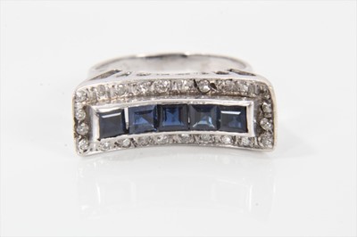 Lot 282 - Sapphire and diamond cocktail ring, the concave rectangular plaque with a line of five calibre cut blue sapphires surrounded by a border of single cut diamonds in 18ct white gold setting on plain s...