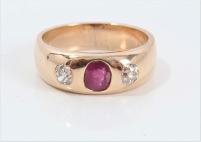 Lot 288 - Victorian ruby and diamond three stone gypsy ring with an oval mixed cut ruby measuring approximately 5mm x 4mm x 2.45mm in gold rub-over setting on wide gold band, ring size M.