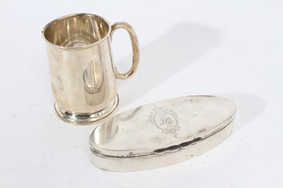 Lot 298 - George V silver trinket box of oval form, with hinged cover and engraved initials, (Sheffield 1910), maker James Dixon & Sons, 13.6cm in length, together with a George V silver Christening mug (Bir...