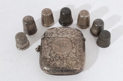 Lot 297 - Victorian silver vesta case of rectangular cushion form with engraved foliate and scroll decoration, (Birmingham 1895), maker John Edward Wilmot, together with five silver and two silver plated thi...