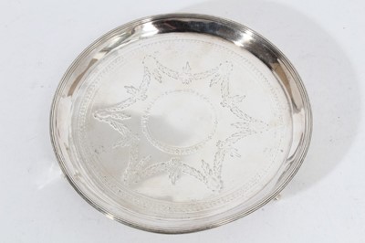 Lot 256 - George III silver waiter of circular form with brite cut engraved decoration and reeded border, raised on three pad feet, (London 1781), maker Peter & Ann Bateman, all at approximately 9oz, 17.8cm...