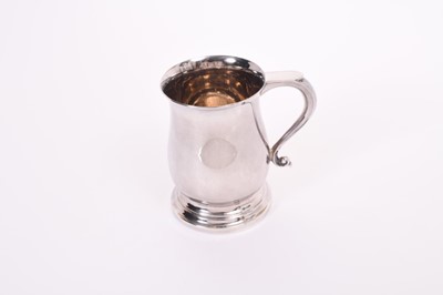 Lot 251 - Elizabeth II silver mug of baluster form with scroll handle, on circular foot, (London 1969), maker A Chick & Sons Ltd, at approximately 8oz, 10.4cm in height