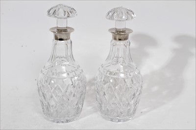 Lot 254 - Pair of good quality Elizabeth II cut glass decanters with mushroom stoppers and silver collars (Birmingham 1964), maker Garrard & Co, each 25.5cm in overall height (2)