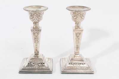 Lot 259 - Pair of Elizabeth II silver Adam style candlesticks with tapered stems, urn shaped candle holders with removable sconces, on stepped bases, (London 1967), maker D J silver, 14.5cm in height