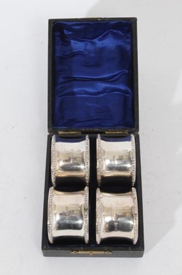 Lot 279 - Set of four George V silver napkin rings of pinched form with egg and dart borders, (Birmingham 1913), maker Charles Edwin Turner, in a velvet lined fitted case, all at 4oz