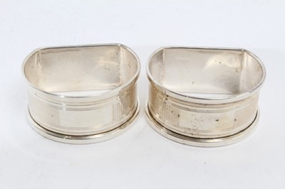 Lot 281 - Pair of Elizabeth II silver napkin rings of oval form, engraved Tom & Sara (Birmingham 1965), maker Garrard & Co Ltd, together with another pair of silver napkin rings similarly engraved (Birmingha...
