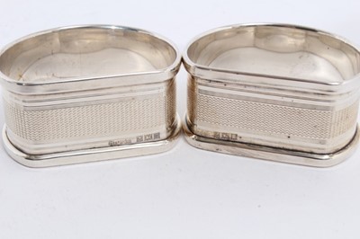 Lot 281 - Pair of Elizabeth II silver napkin rings of oval form, engraved Tom & Sara (Birmingham 1965), maker Garrard & Co Ltd, together with another pair of silver napkin rings similarly engraved (Birmingha...