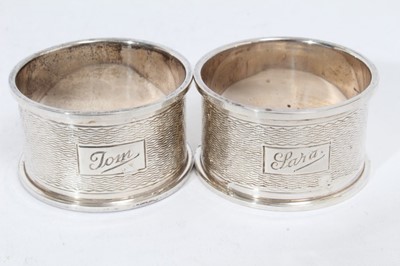 Lot 281 - Pair of Elizabeth II silver napkin rings of oval form, engraved Tom & Sara (Birmingham 1965), maker Garrard & Co Ltd, together with another pair of silver napkin rings similarly engraved (Birmingha...