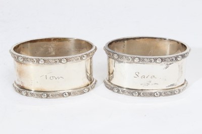 Lot 281 - Pair of Elizabeth II silver napkin rings of oval form, engraved Tom & Sara (Birmingham 1965), maker Garrard & Co Ltd, together with another pair of silver napkin rings similarly engraved (Birmingha...