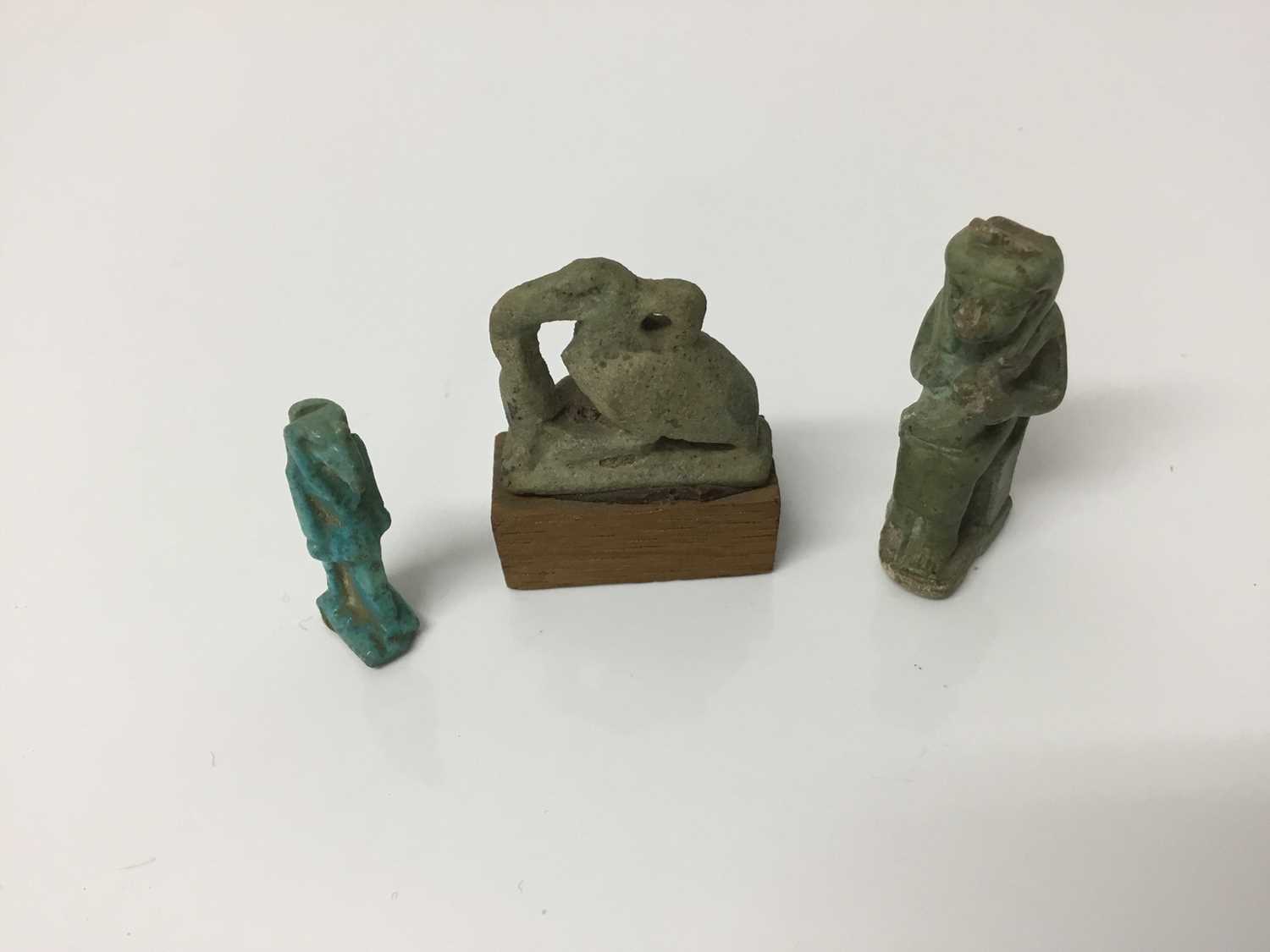 Lot 509 - Ancient Egyptian faience amulets of Isis and Horus, and a blue faience amulet of Anubis, the largest 3.25cm height