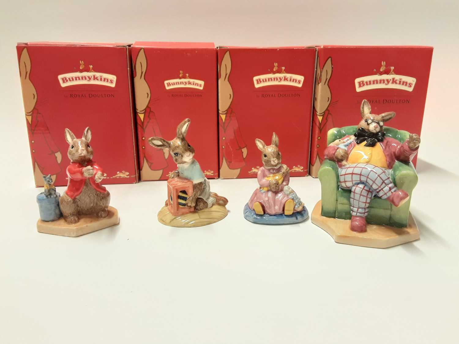 Lot 121 - Royal Doulton Bunnykins polly Dreaming DB468, Easter Treat DB289, William Listening Intently DB442 & Once Upon a Time DB441, boxed