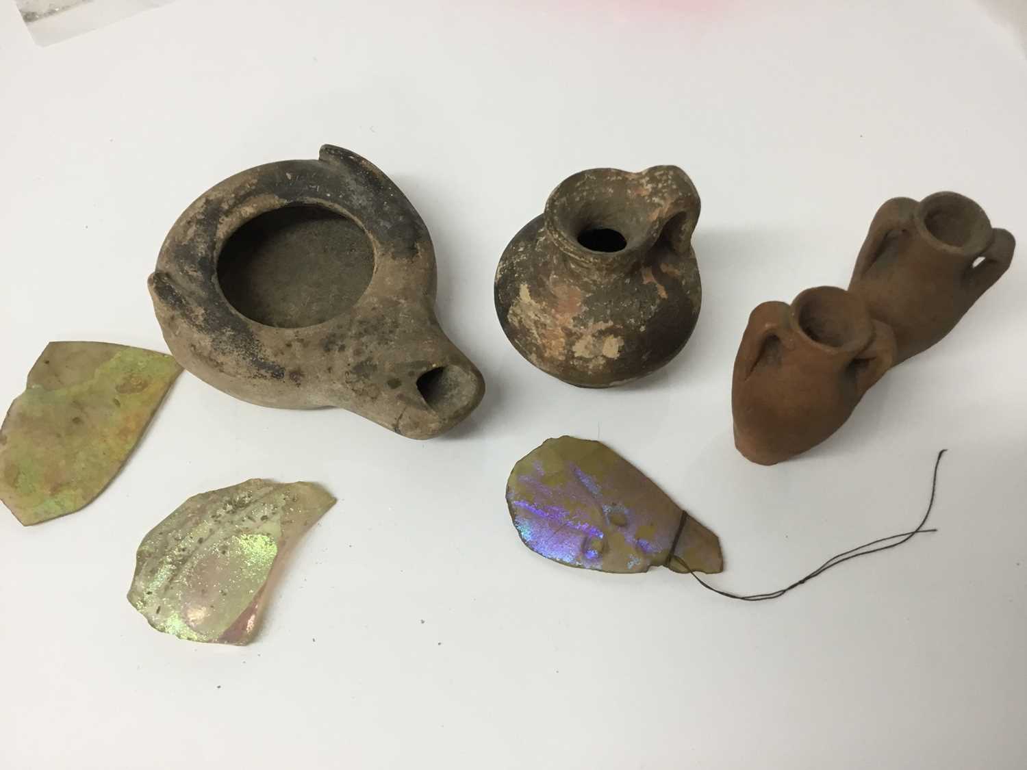 Lot 516 - Roman items, including an oil lamp and flagon, a tiny amulet of Jasper, and some items possibly later, including two amphora and three iridescent glass shards
