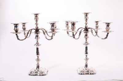 Lot 274 - Pair of Good Quality Elizabeth II Georgian style silver candelabra, each with baluster stems, removable four branches and five candle holders with removable sconces on stepped square bases, (Sheffi...