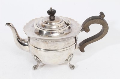 Lot 257 - Edwardian silver teapot of circular form with pie crust border, domed hinged cover with bakelite finial and scroll handle, raised on four claw and ball feet, (Birmingham 1909), maker J Sherwood & S...