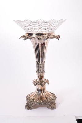 Lot 275 - Impressive 19th century silver plated table centre with tapered central column, relief decoration of fruiting vines and removable cut glass bowl, raised on four scroll feet, marks to underside of b...