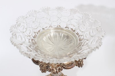 Lot 275 - Impressive 19th century silver plated table centre with tapered central column, relief decoration of fruiting vines and removable cut glass bowl, raised on four scroll feet, marks to underside of b...